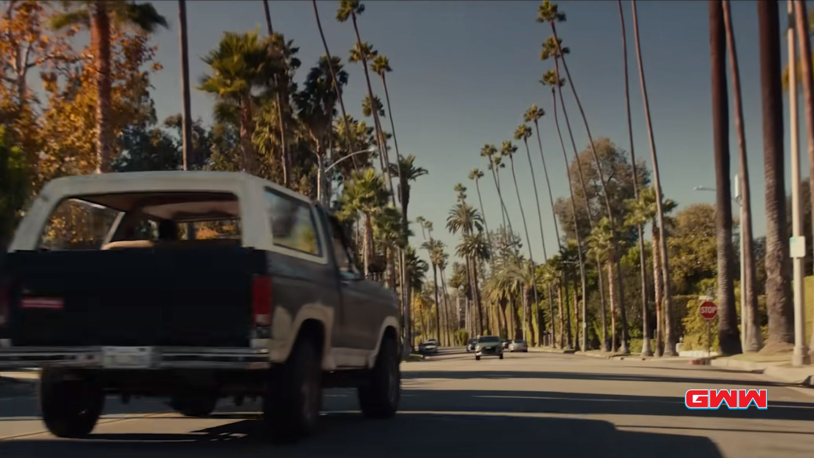 A truck driving through a road with palm trees,  Beverly Hills Cop 4