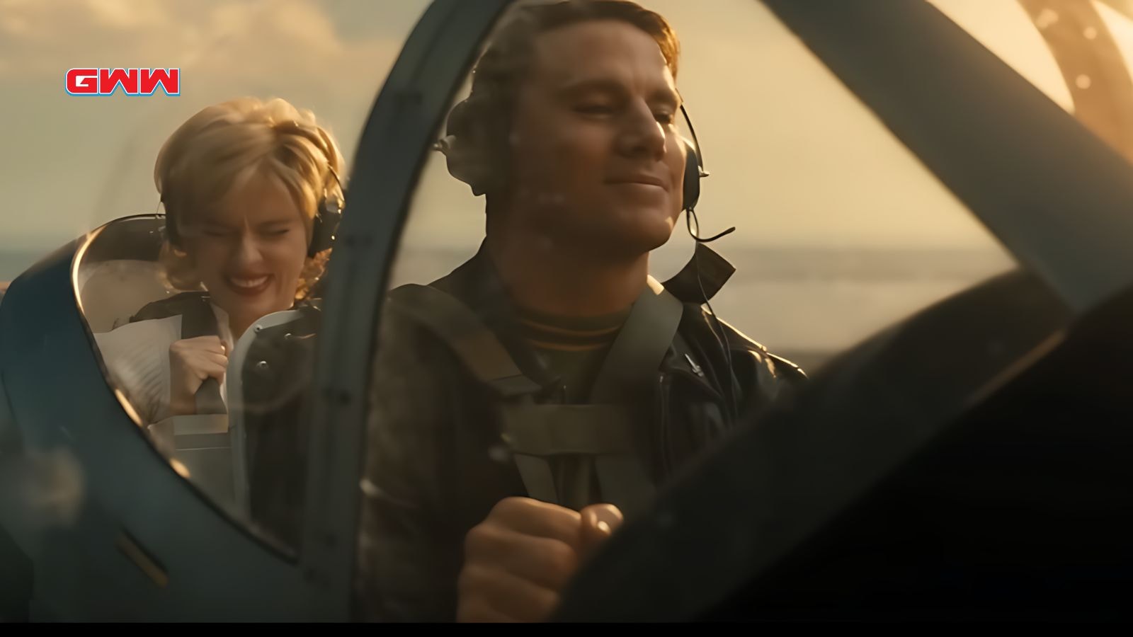 Cole and Kelly smiling in a small airplane cockpit, enjoying their flight together.