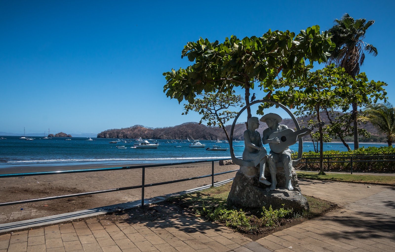 a beautiful statue of a couple on the seashore in one of the best beaches in Costa Rica