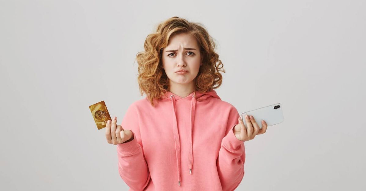 sad woman with a credit card and smartphone