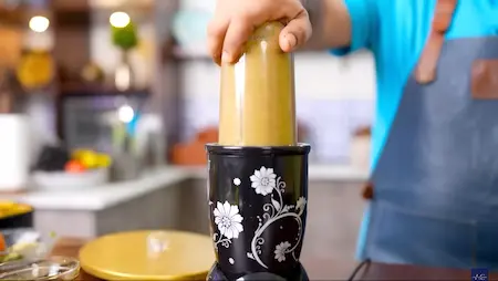 Smooth and consistent green chutney being blended to a fine paste.