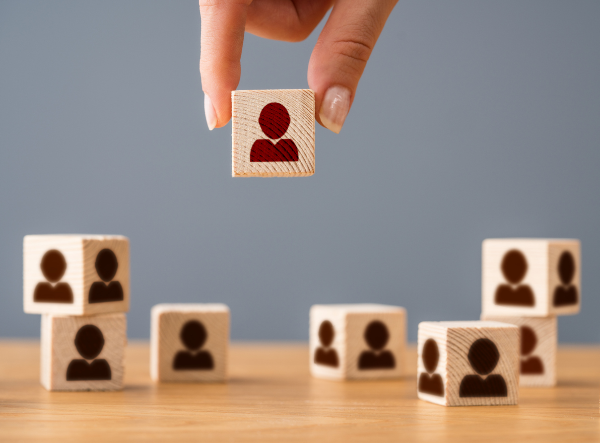 woman picking a cube with a logo of a human