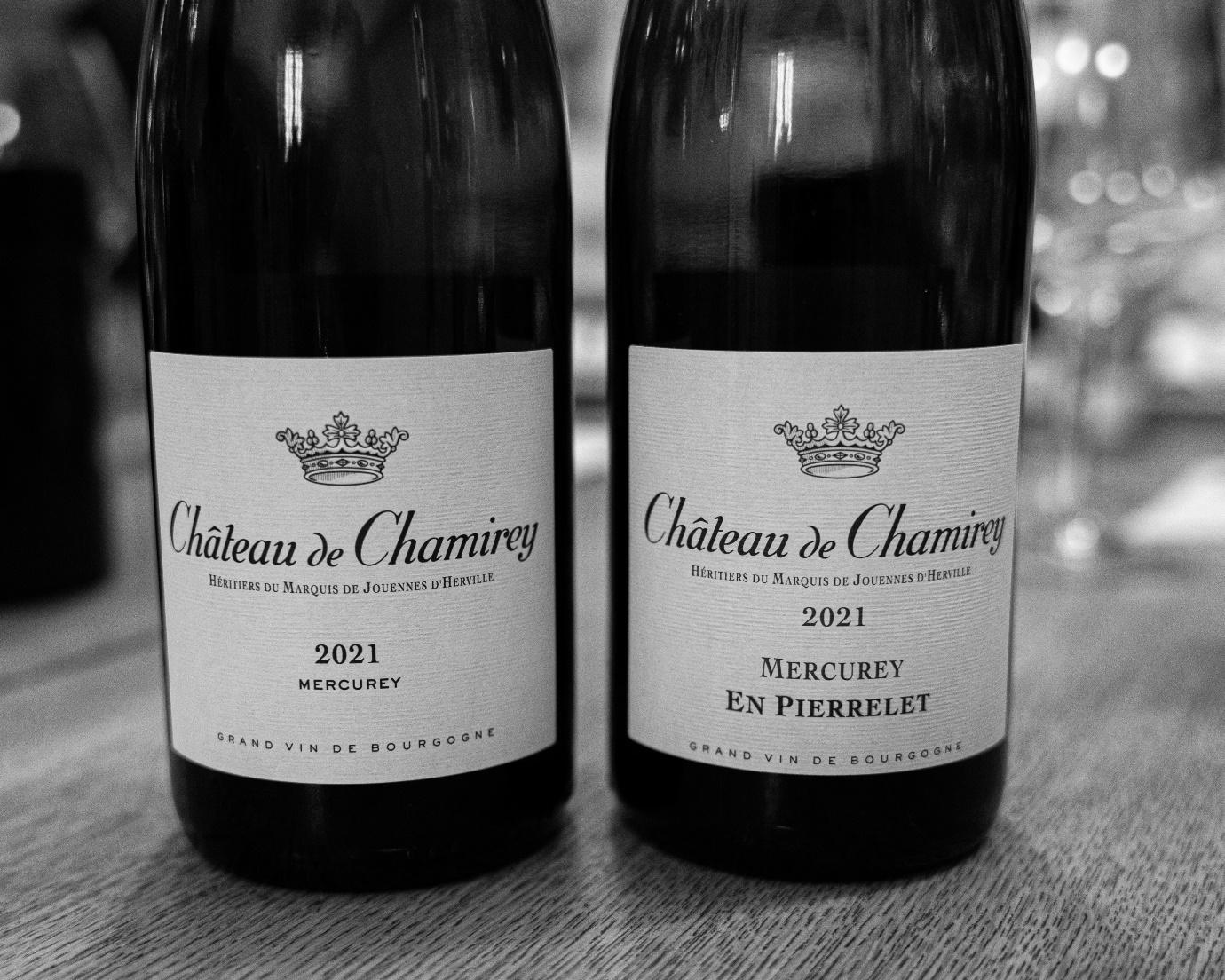 Two bottles of wine on a table

Description automatically generated