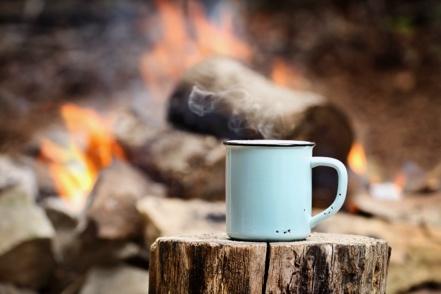 Steel mug by campfire