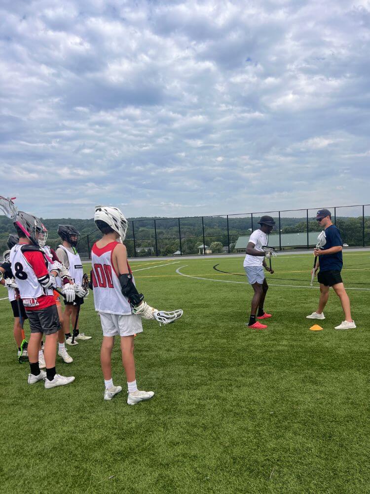 Signature Sports Camps resident coaches doing a demonstration during lacrosse practice