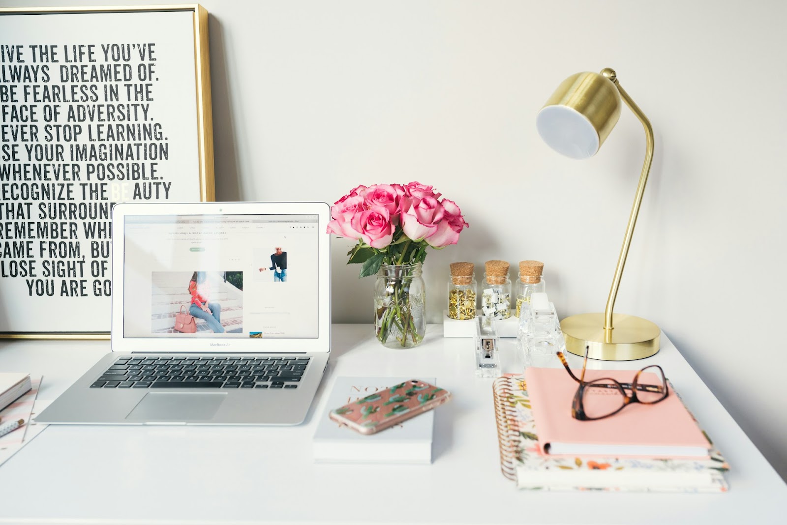 A working table with gadgets and notebooks.