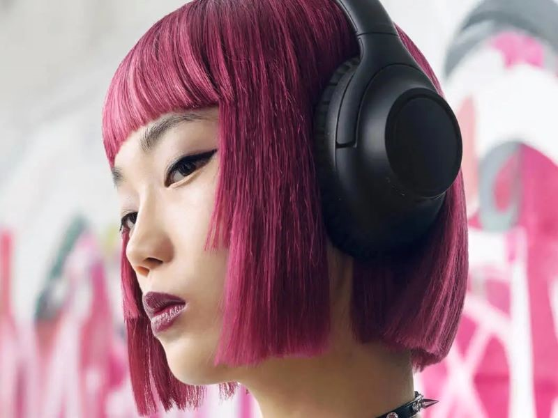 Woman wearing Audio-Technica ATH-S300BT wireless headphones.