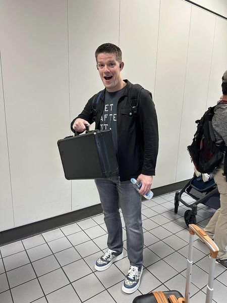 russell holding a briefcase