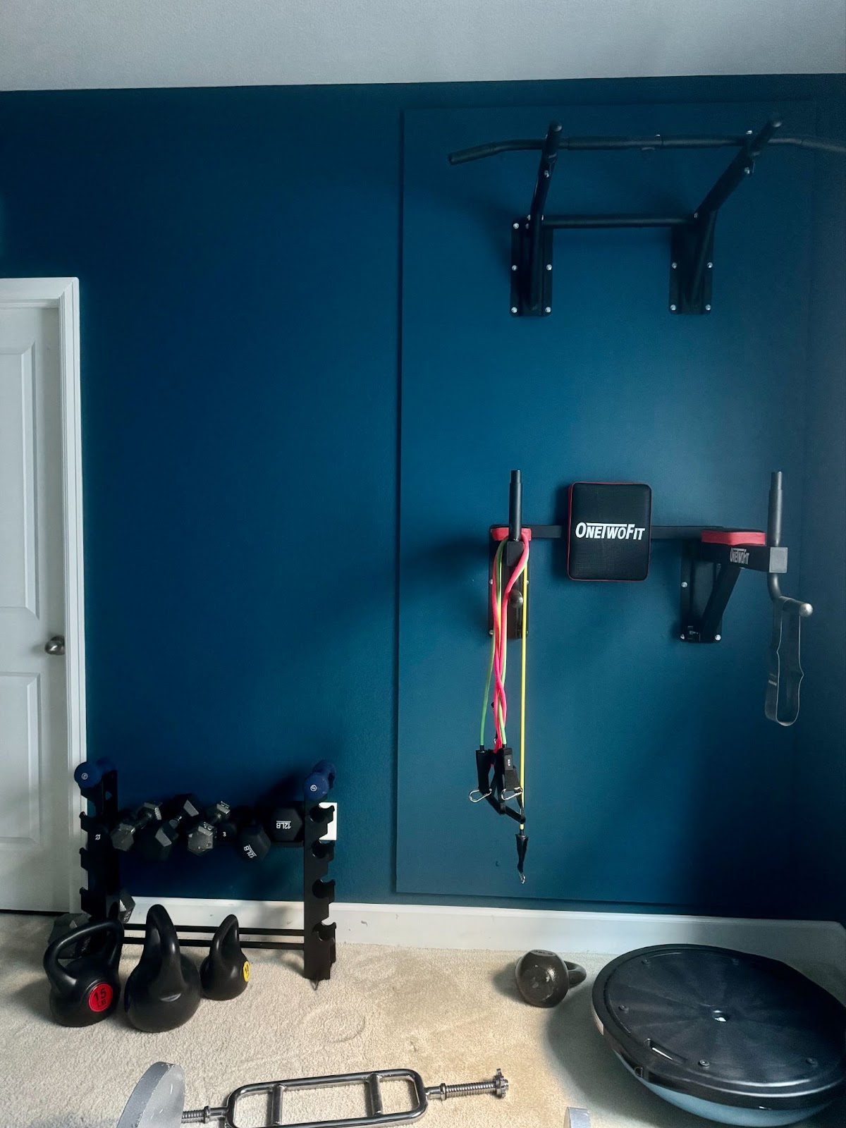 A basement home gym is painted with Benjamin Moore Slate Teal 