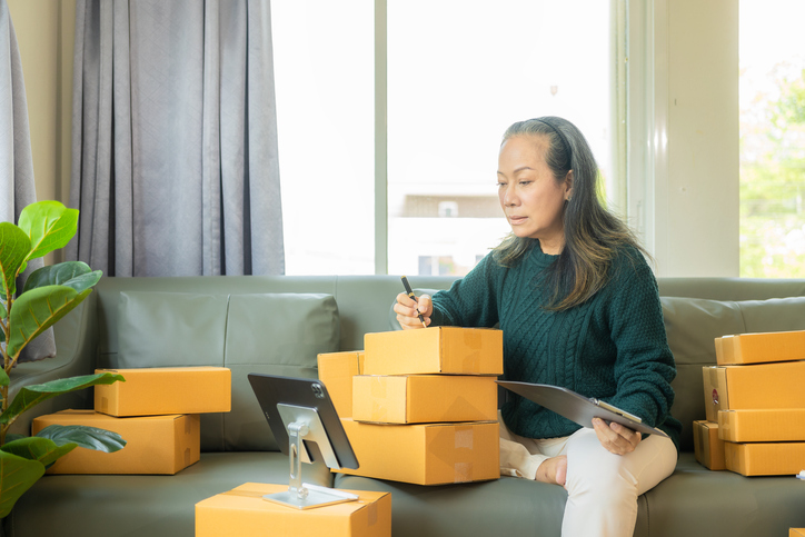 Woman labeling and organizing storage boxes.