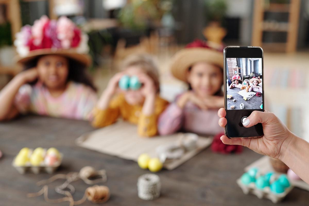 kids posing for a photo taken by a phone