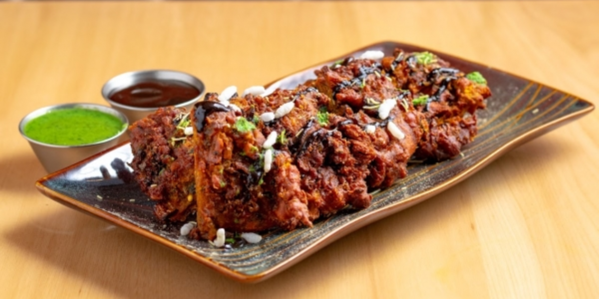 A plate of tandoori chicken with yogurt and herb marinade, cooked in a tandoor oven.