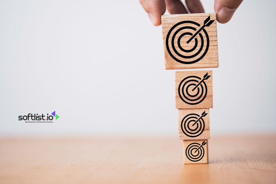 Stacking wooden blocks with target icons for business goals