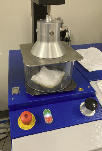 A machine tests the efficiency of a respirator in a lab.