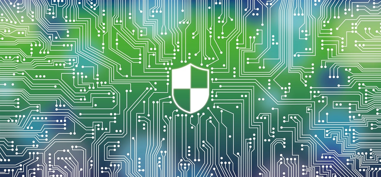 A digital illustration of a circuit board with a shield icon at the center, set against a green and blue gradient background.
