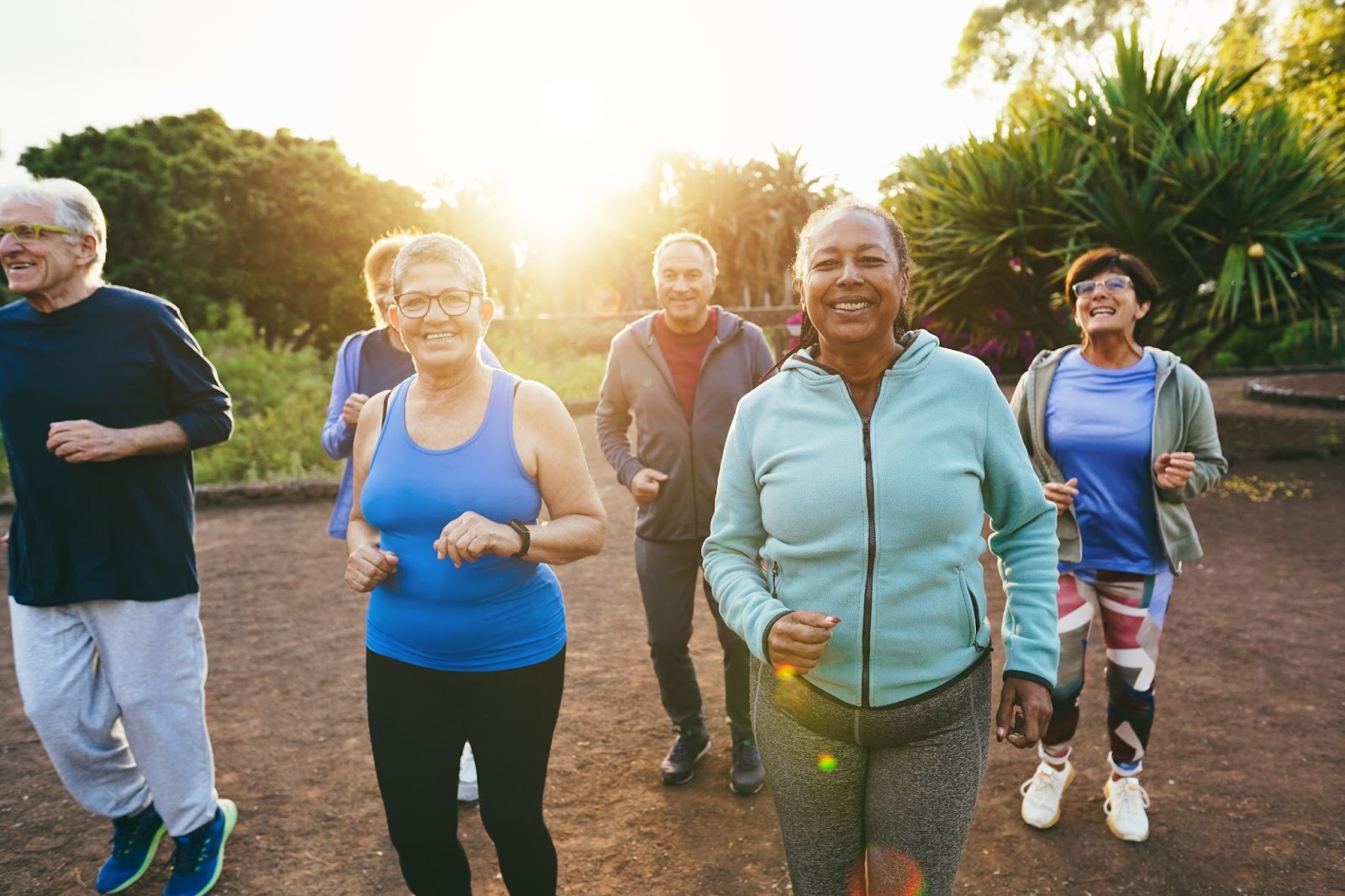 A group of happy seniors jog in a park together