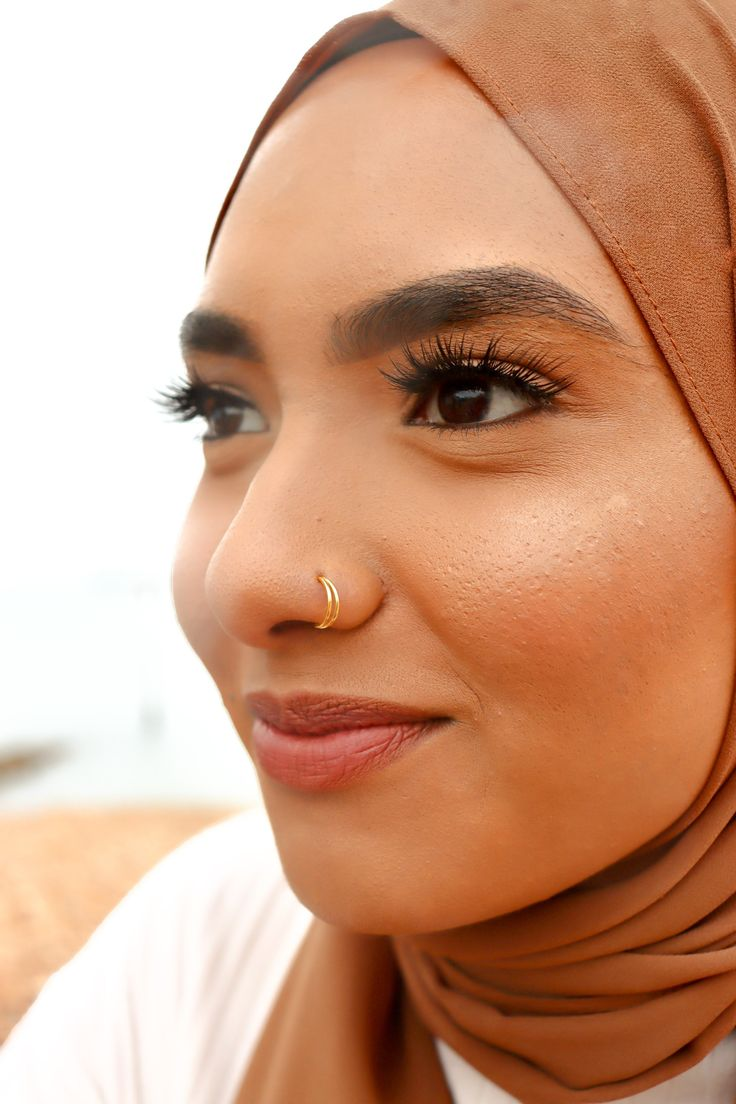 Types of nose  piercing: Picture of a lady adorning herself with one of the cute blings