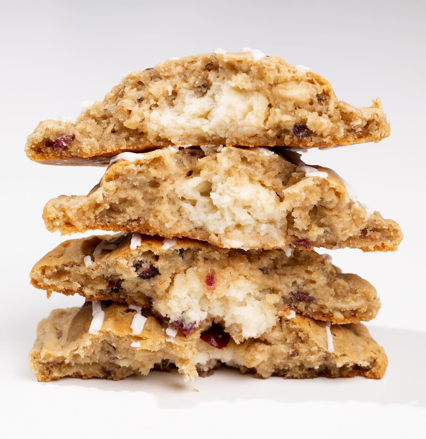 Stack of cookies split in half, inside of the cookie is filled with layers of mix-ins