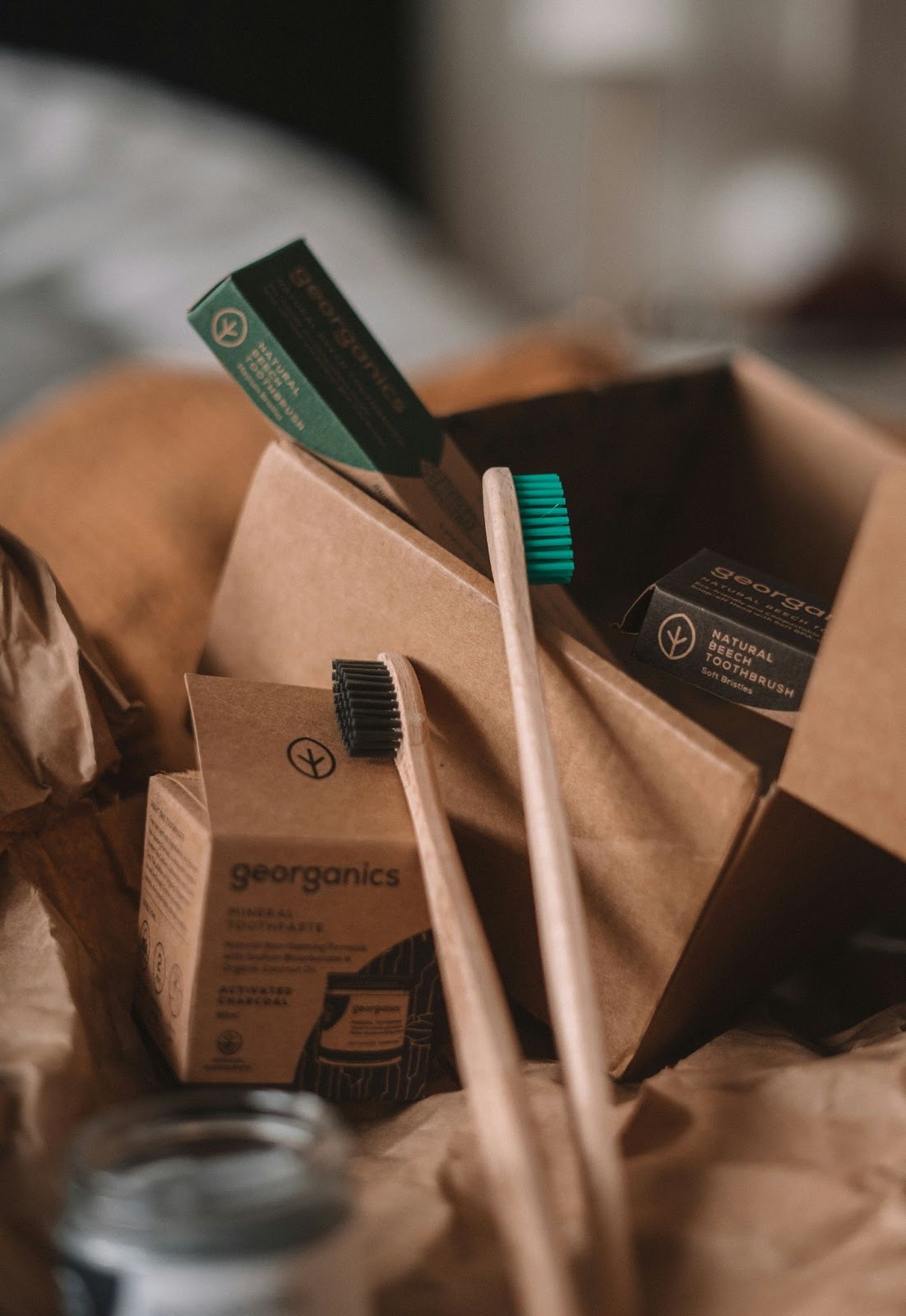 Eco-friendly dental products including bamboo toothbrushes and natural toothpaste in sustainable packaging.