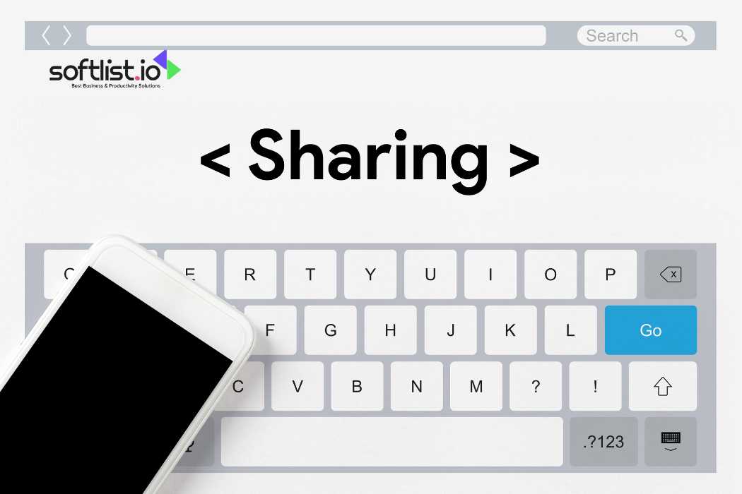 Smartphone on a keyboard with "Sharing" typed in a browser search bar