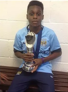 A young Jeremie Frimpong celebrates a trophy for Manchester City’s Youth squad