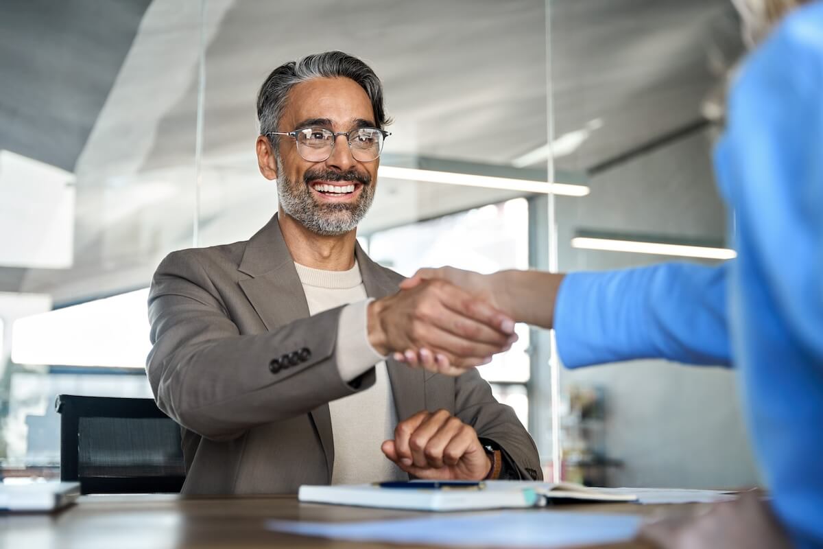 Entrepreneur shaking hands with an employee