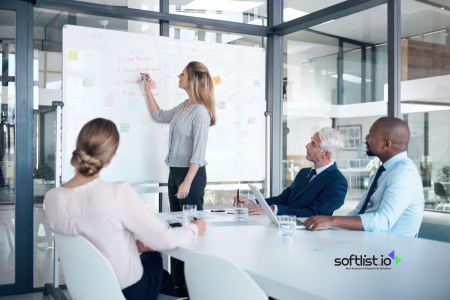 Businesswoman presenting strategy to colleagues in a modern conference room.