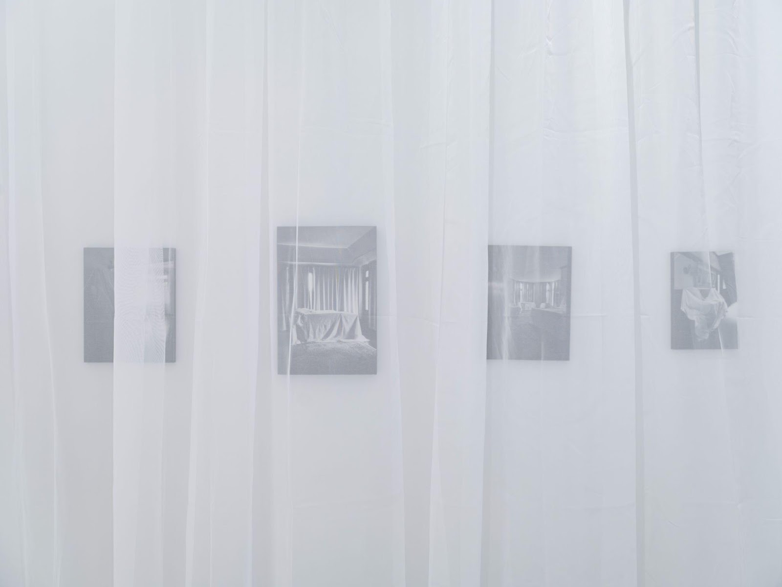 A white curtain with pictures on it

Description automatically generated