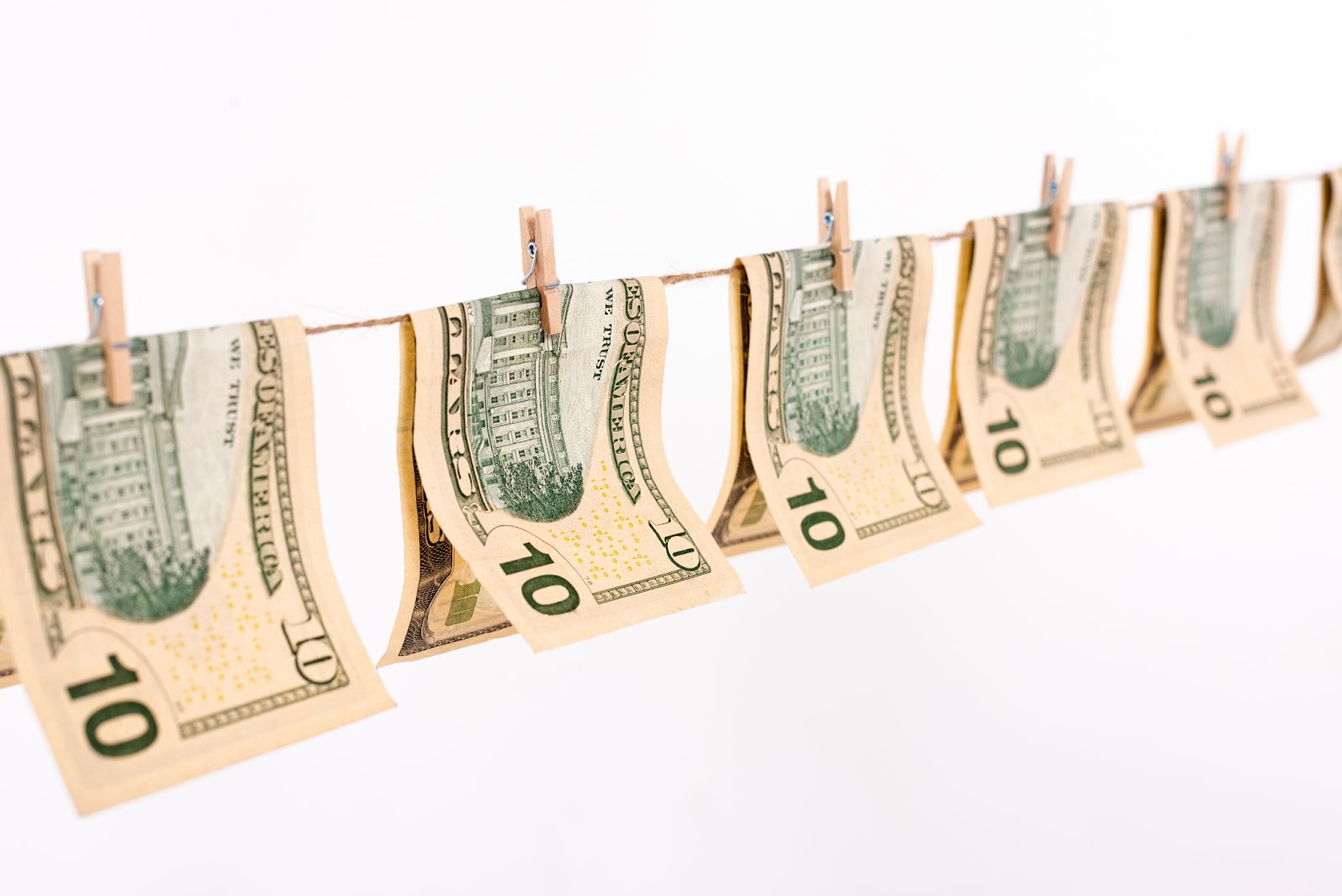 Side view of banknotes hanging on a clothesline