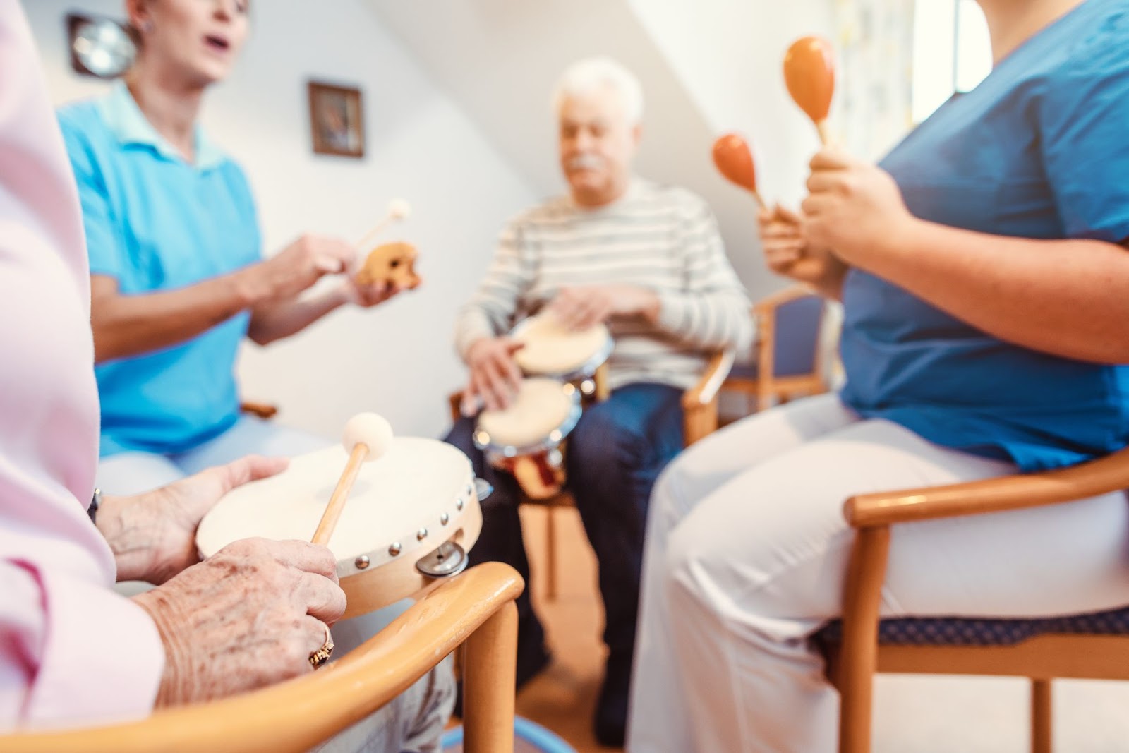 A group of residents engaging in music therapy in a memory care community.