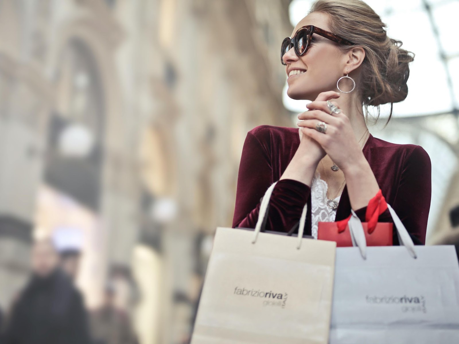 a woman with branded shopping bags
