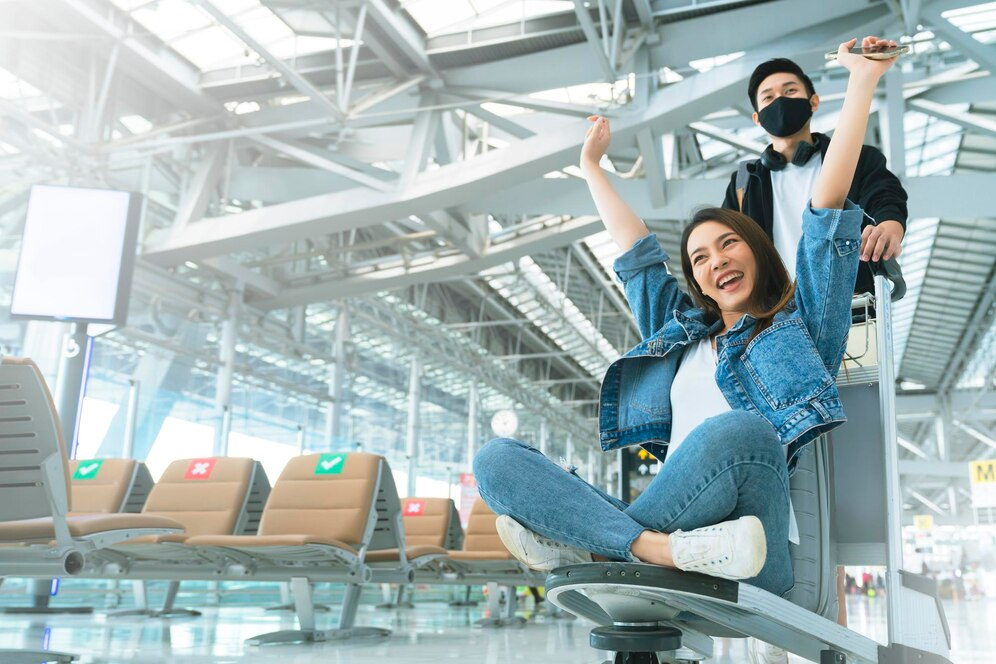 A person sitting on a chair with her arms raised

Description automatically generated