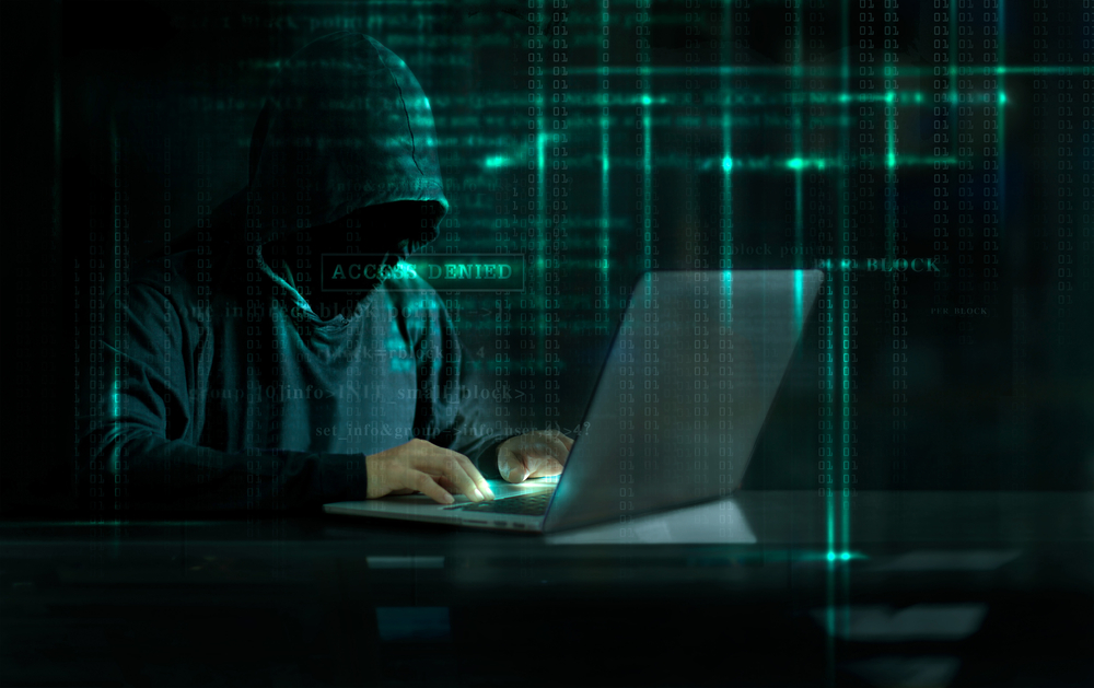 Graphic showing a hooded hacker