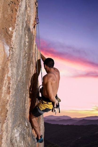 Man climbing on a mountain with safety equipment