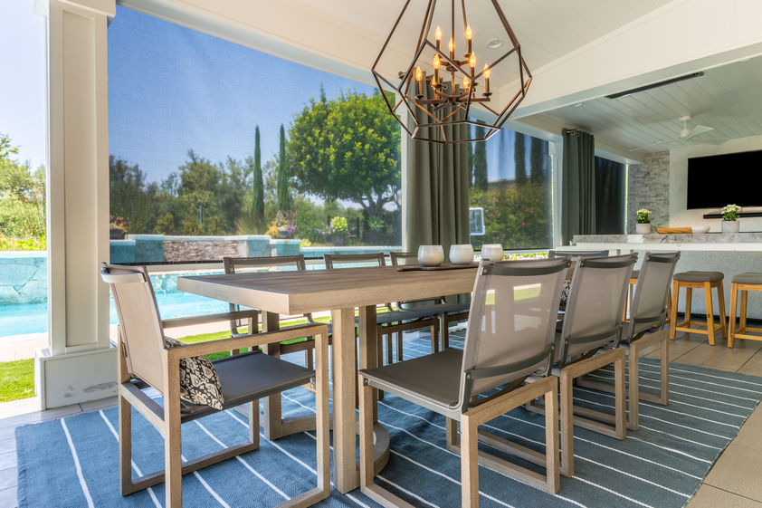 Back porch with solar shades to control light and pool in background