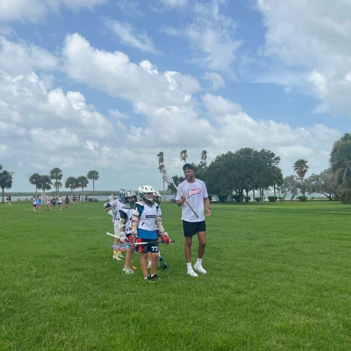 Dhane Smith coaching a young group of lacrosse players at Signature's overnight sports camp