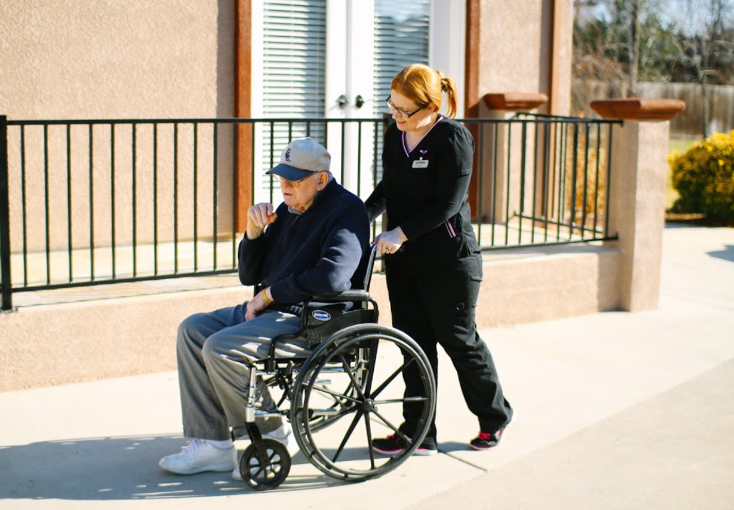 staff helping person in wheelchair