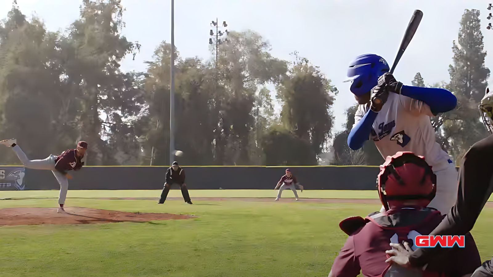 Damon delivering a pitch, batter ready to swing, umpire and catcher watch.