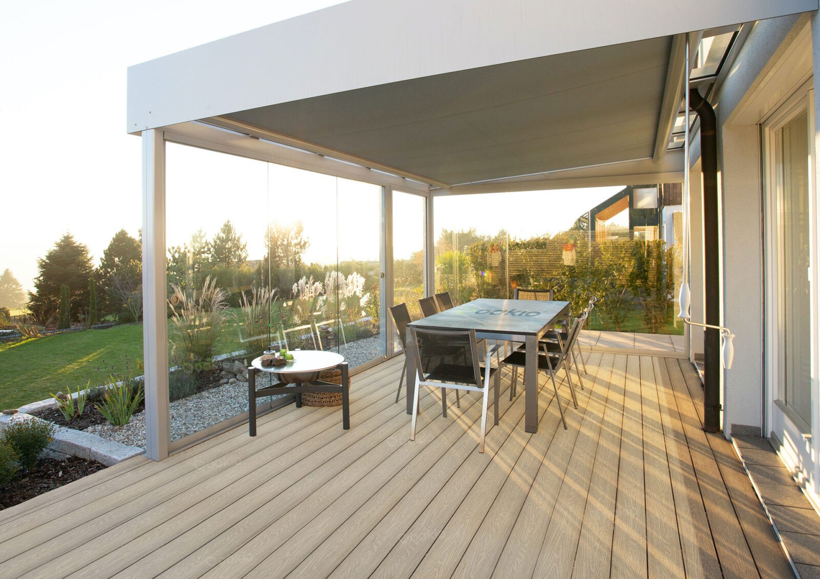 A modern deck with a set of chairs and tables for al-fresco dining