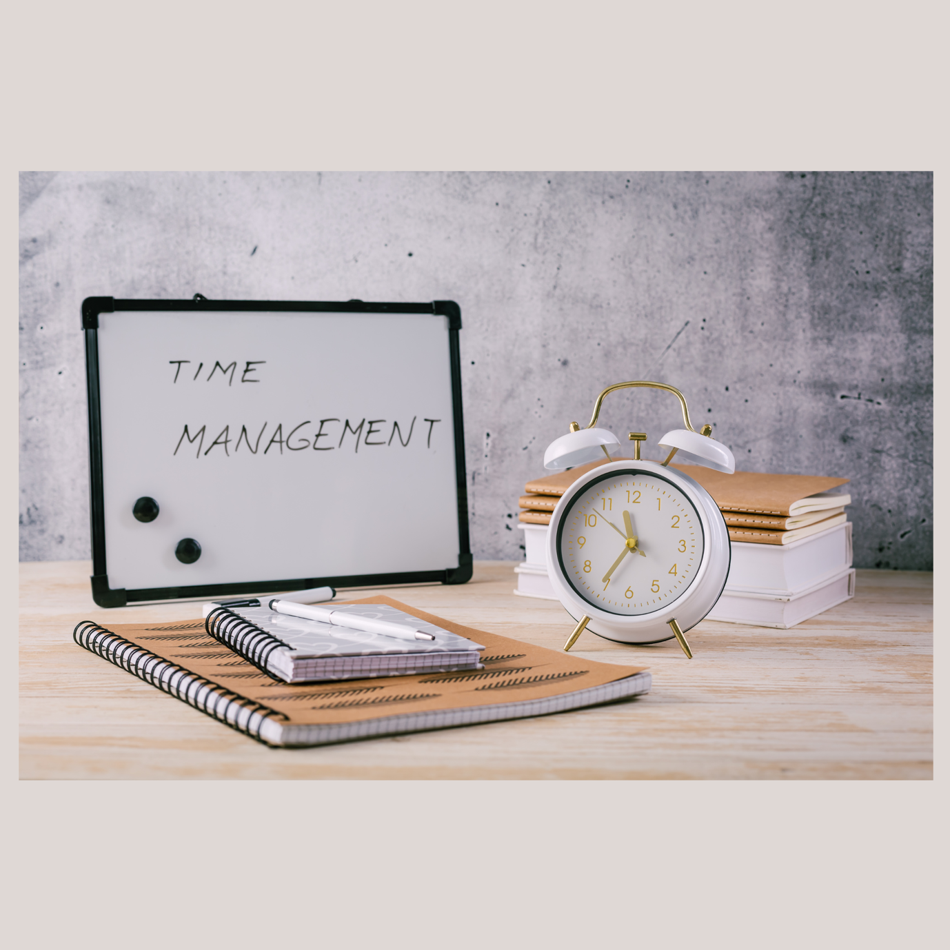 A white board with a clock and notebooks on a table<br />
<br />
Description automatically generated