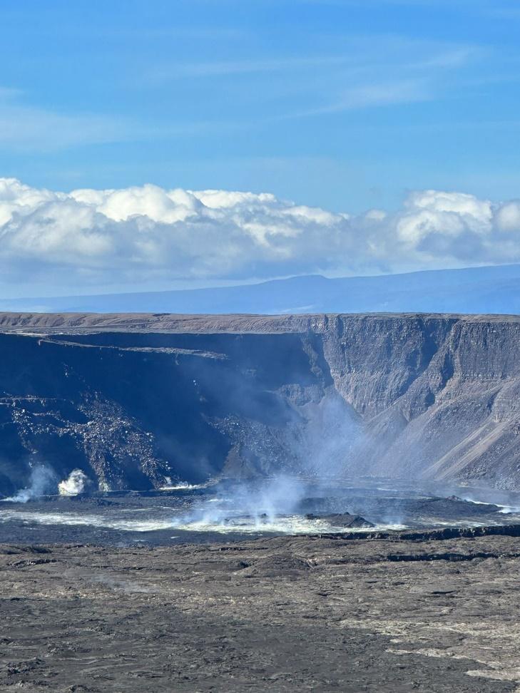 A large crater with smoke coming out of it

Description automatically generated