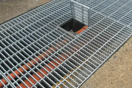 Steel grating used to cover and provide access to underground pipes.