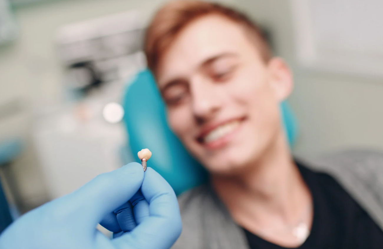 Dentist holding implant
