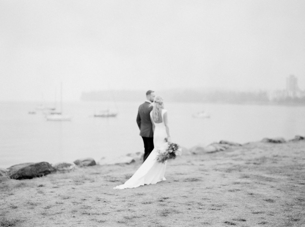 Couple walking through the beach on their wedding day