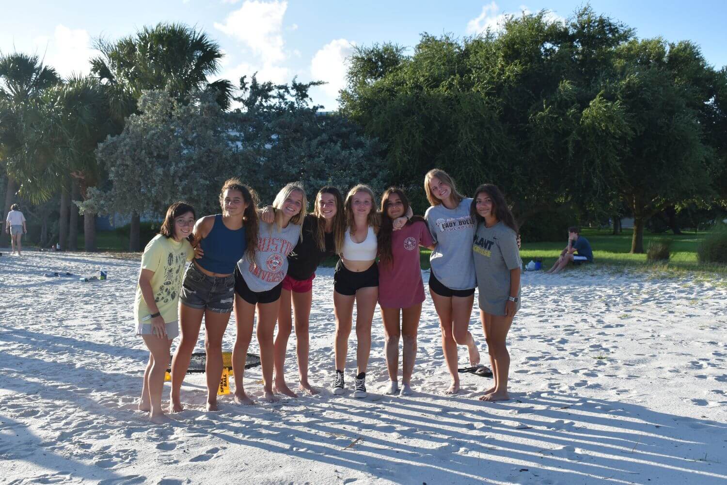 A group of girls locked arms on the beach at overnight summer camp