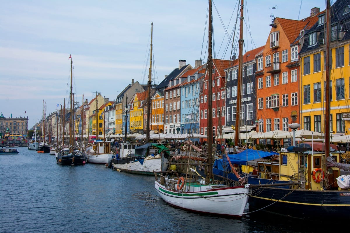 Boats in a lake and colourful buildings in Denmark.