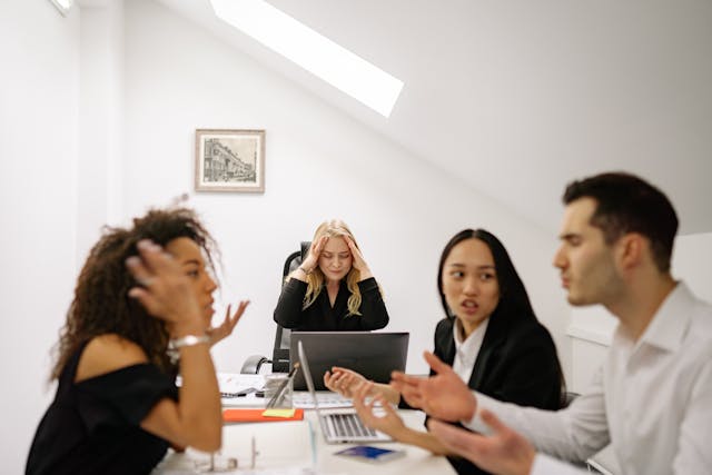 A diverse group of professionals engaged in disagreements.