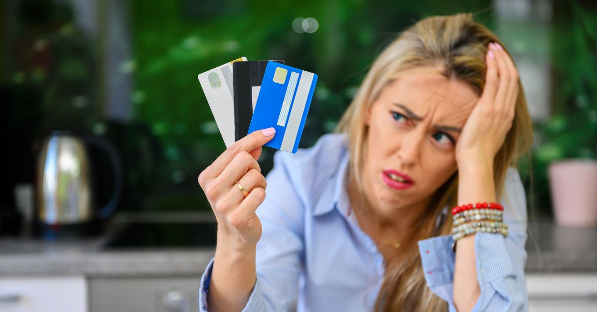 frustrated woman with credit cards in her hand