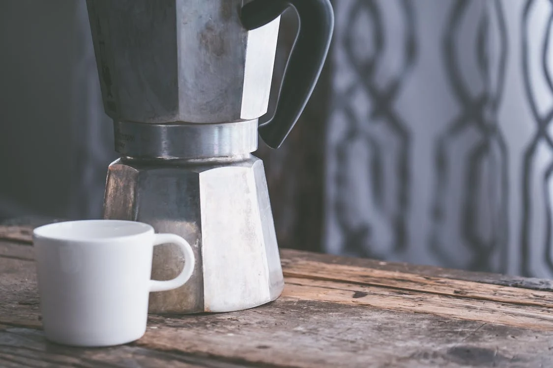 a coffee maker and a mug