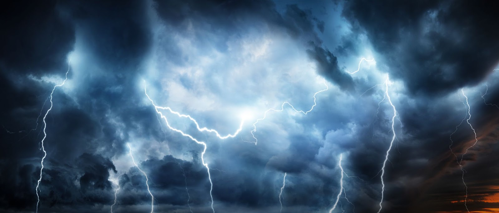 A turbulent sky showcasing ominous clouds and striking lightning, creating a powerful and electrifying scene.
